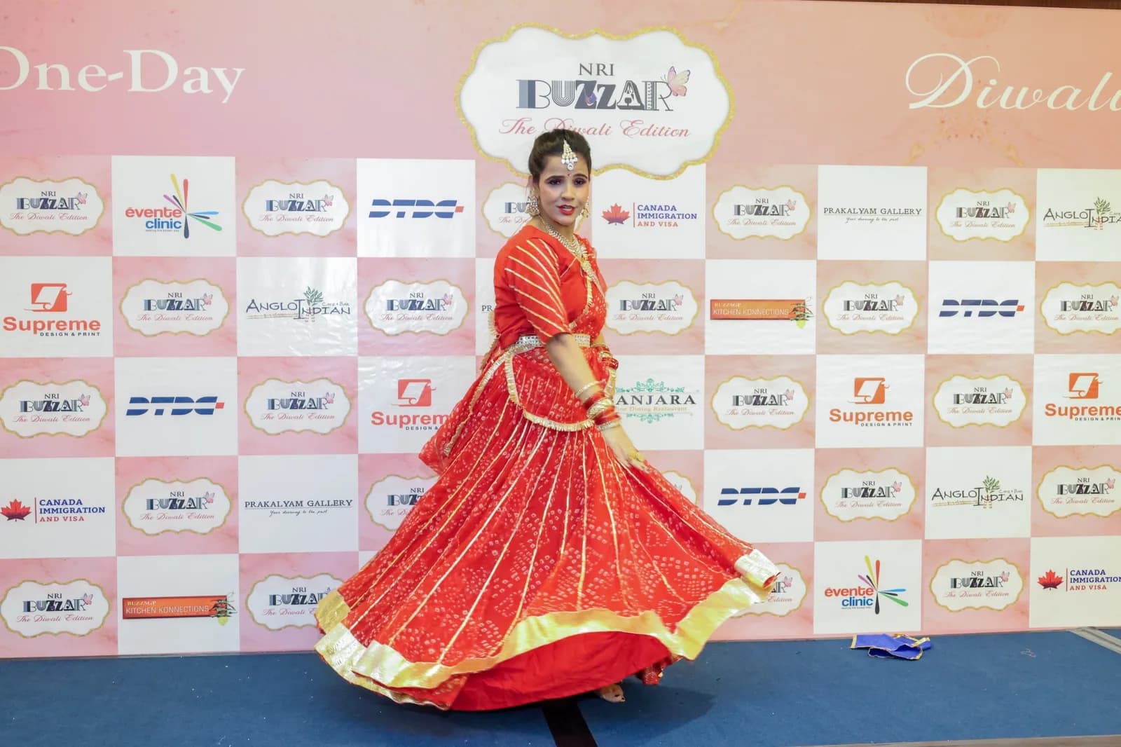 A dancer spinning in a red lehenga at NRI Buzzar